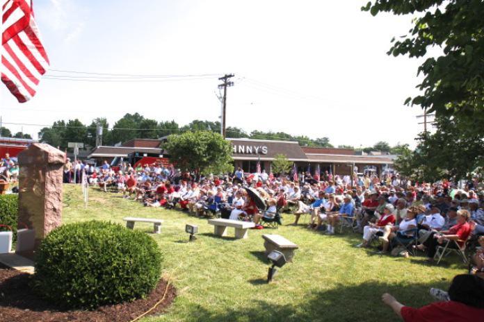 The Former Johnny's Market is in background of Memorial Day ceremony.