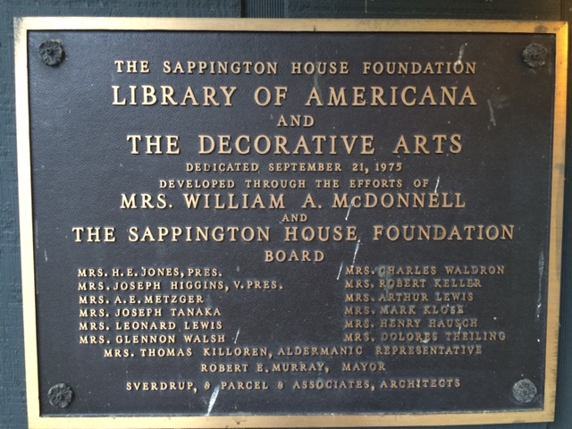 Bronze plaque next to entrance to Library of Americana